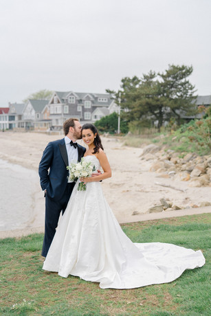 groom kissing bride on the beach at waters edge Westbrook 