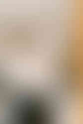 Groom putting on cologne at Waveny House