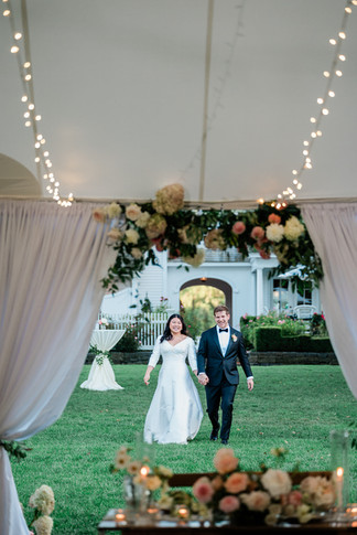 newlyweds entering smith farm gardens wedding reception