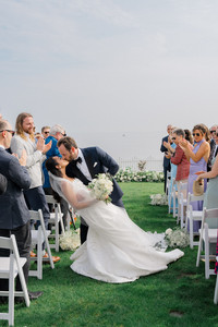 groom dipping bride and kissing her at waters edge resort and spa Westbrook wedding ceremony