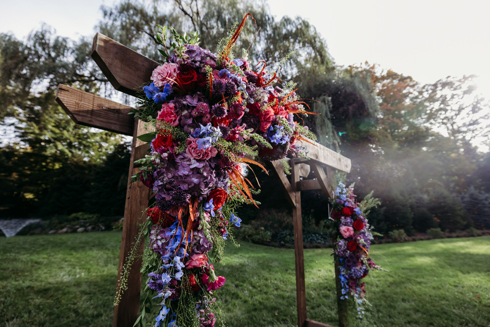 Chuppah with jewel tone florals at The Woodwinds wedding