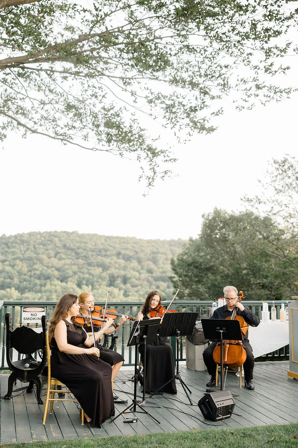 Classical wedding musicians performing as a string quartet for a saint clements castle wedding cocktail hour in Portland connecticut.