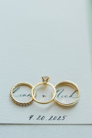 Close-up of wedding rings on invitation card at Smith Farm Gardens wedding