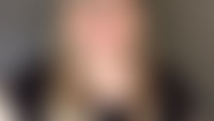 Laura Maxwell, founder of Called to Care nonprofit, smiling in black top with glasses and hoop earrings against gray background