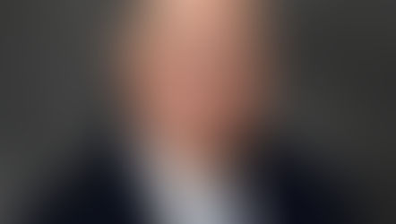 John Crawford government affairs principal Coleman Talley Strategies wearing dark suit blue striped tie professional headshot