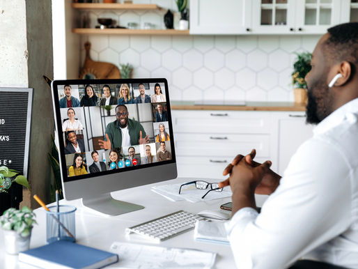 Man in a home office joins an online business mastermind video call, representing breakthrough groups that help entrepreneurs plan for succession and growth.