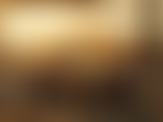 Construction workers in hard hats and safety vests gather around a table at a construction site during sunset, reviewing plans amid skeletal framework and building materials