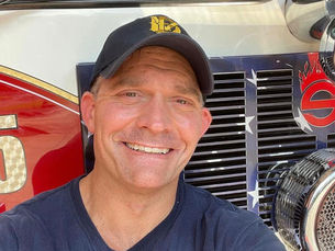 Josh Knight, a fire lieutenant in uniform, smiling confidently after six years of sobriety through Redeemed Living recovery program