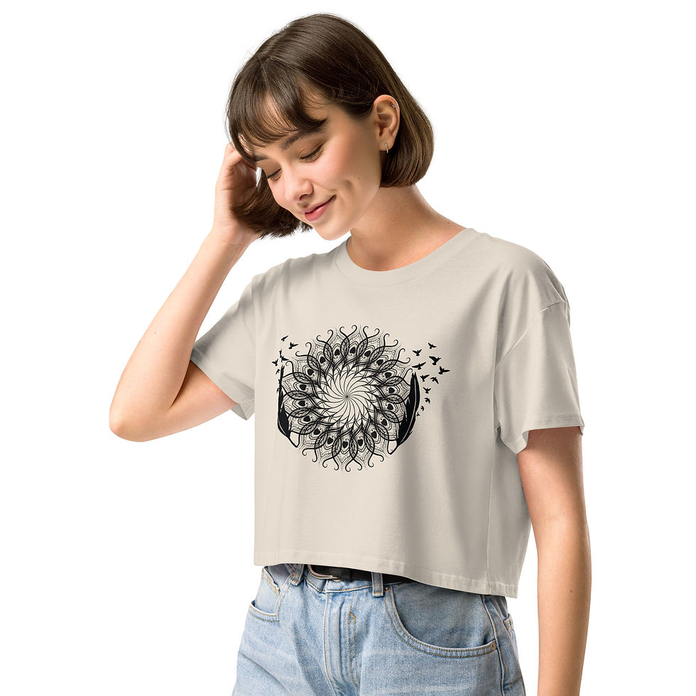 Thumbnail: Model standing wearing the women’s crop top in Bone, featuring the ‘Feathered Rising’ artwork, front view.