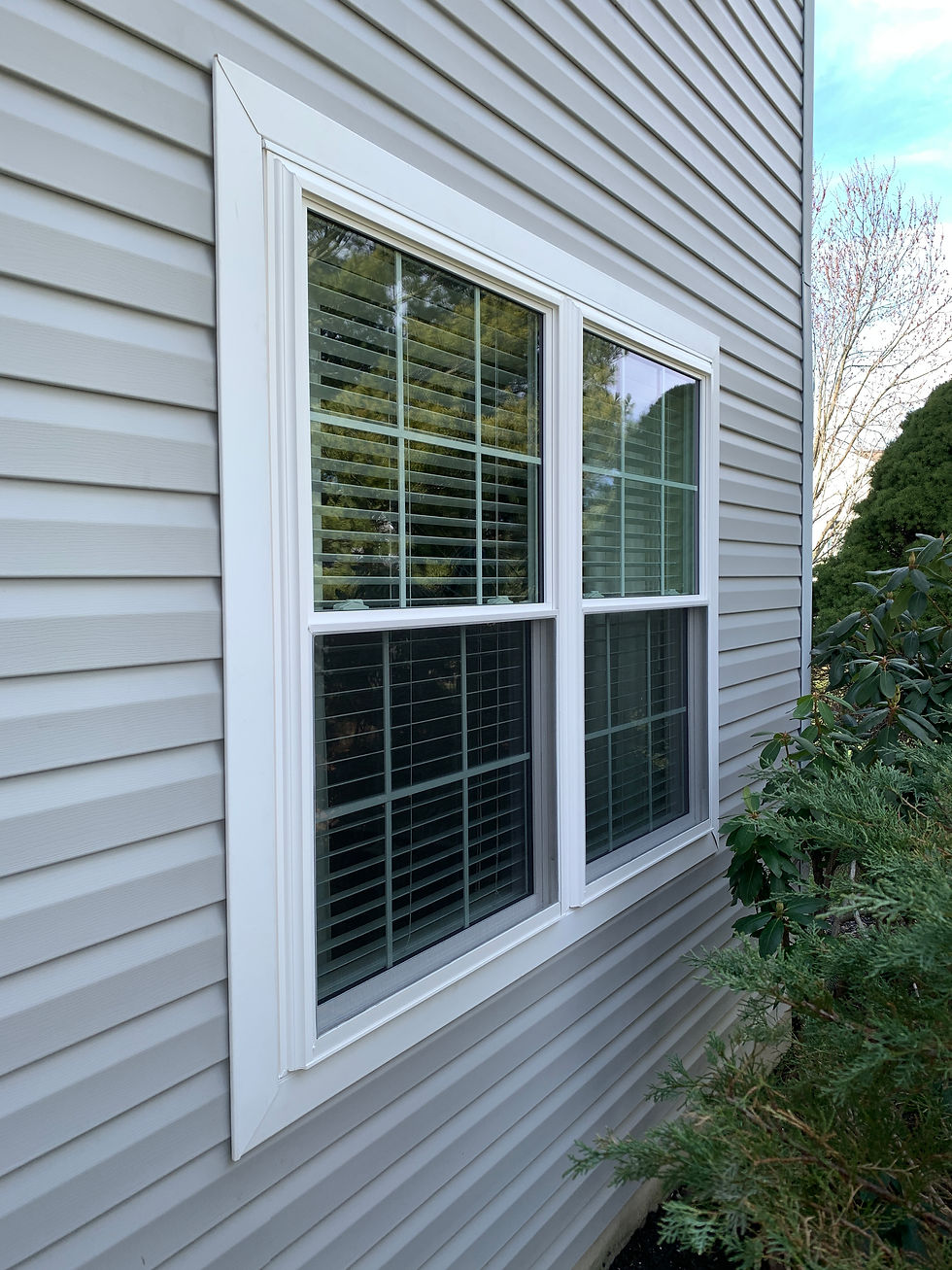 Vinyl window replacement by Archer Exteriors.