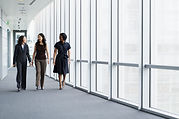 Businesswomen Walking in Hallway