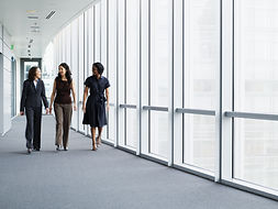 Business Women Walking in Hallway