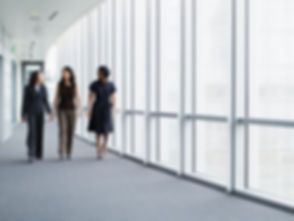 Businesswomen Walking in Hallway