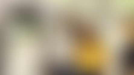 Smiling couple in a bright room, with a woman in yellow and a man in gray. Another woman gestures towards them. CRS Data logo visible.