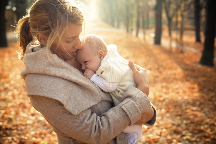Mother and baby in autumn