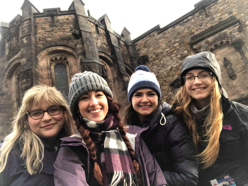 Selfie of four friends in front of Edinburgh Castle