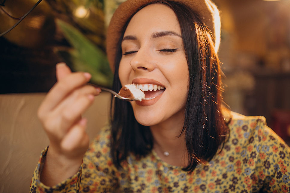 young-woman-eating-delicious-tiramisu-in-a-cafe.jpg