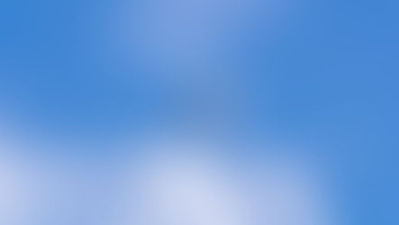Diamond Da40 flying against a bright blue sky with scattered clouds, viewed from below. The scene feels serene and open.