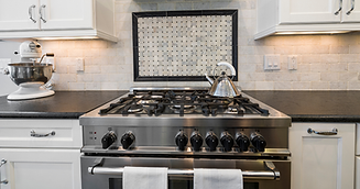 Oven and cooktop repair Calgary - Red Seal certified technician servicing a range.png