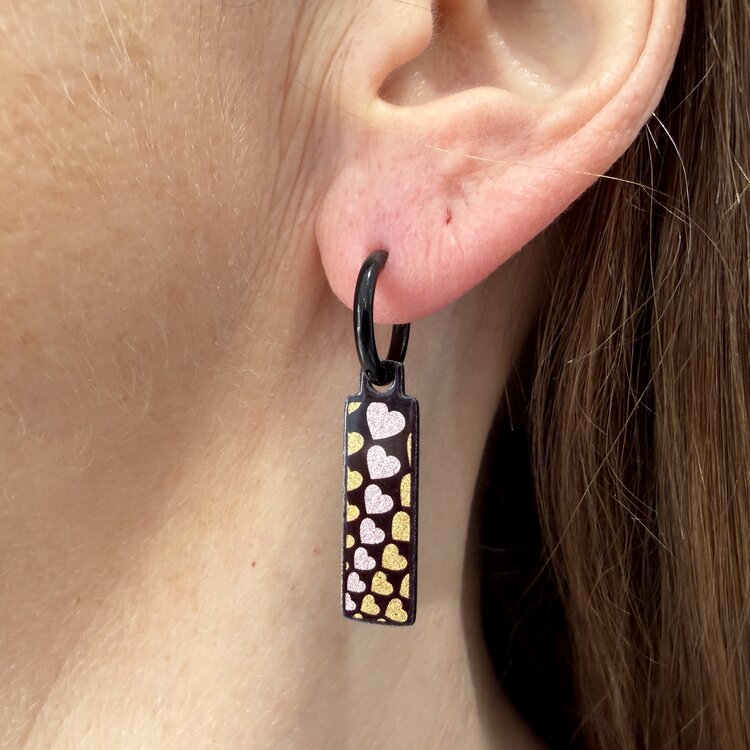 Double-sided 8mm x 24mm rectangular stainless steel drop earrings featuring the With Love gold infinity design in a metallic finish. The slim double-sided drops show the artwork from either side and create a clean, contemporary look. by Urband London