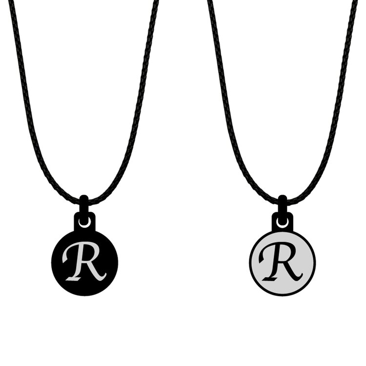 A double-sided 14mm round stainless steel pendant featuring the Initial R black and silver design in a metallic finish. The artwork is visible on both sides, giving the pendant a distinctive look from every angle. by Urband London