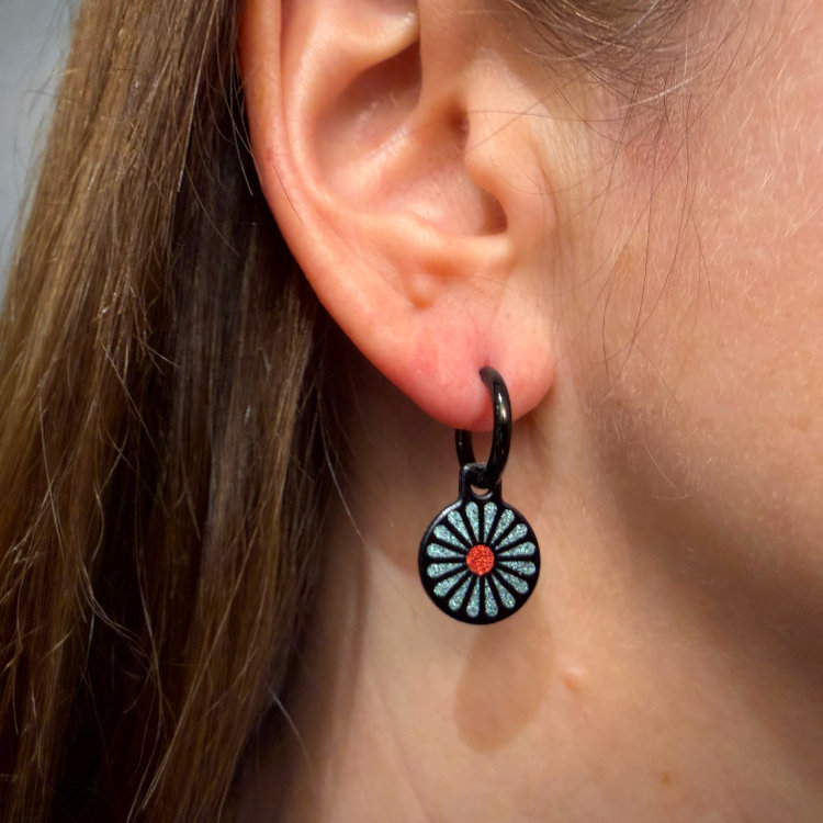 Double-sided 14mm round stainless steel drop earrings featuring the Flowers Garden bright pastels design in a metallic finish. The artwork appears on both sides of the drops, so the design remains visible as they move. by Urband London