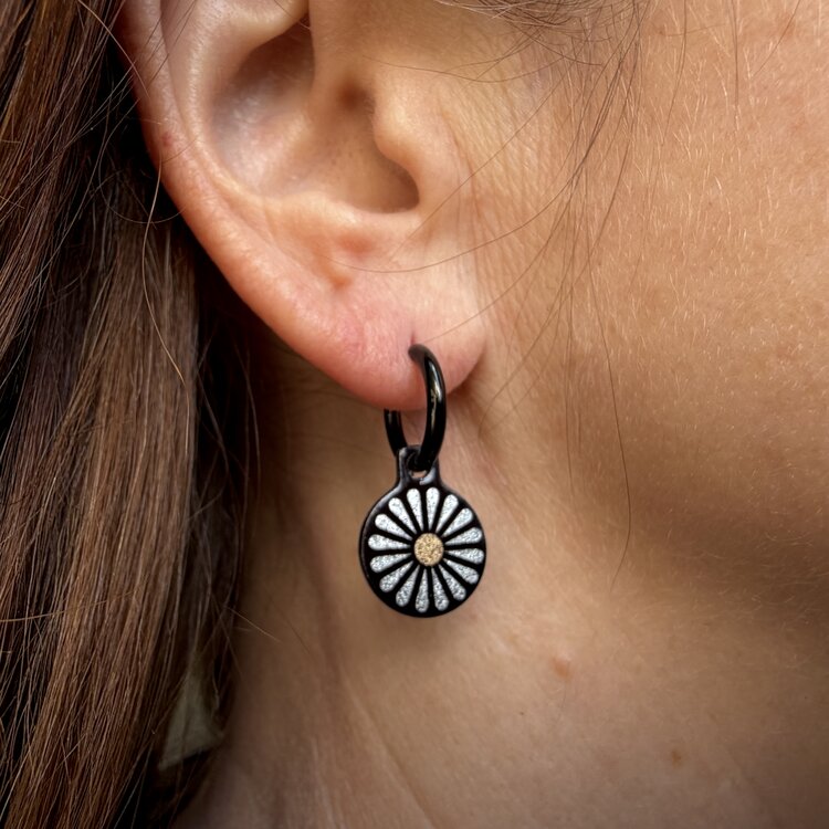 Double-sided 14mm round stainless steel drop earrings featuring the Flowers Garden silver petals design in a metallic finish. The artwork appears on both sides of the drops, so the design remains visible as they move. by Urband London