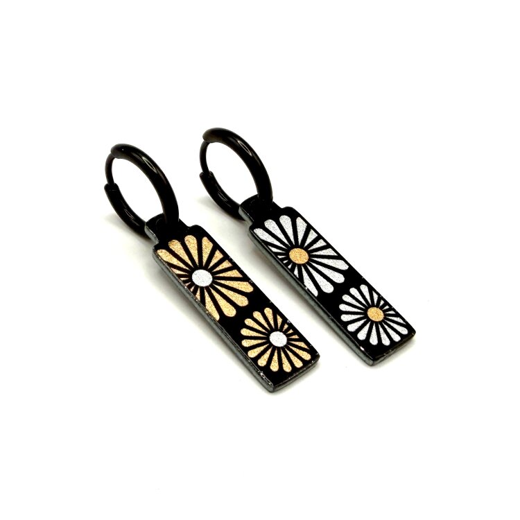Double-sided 8mm x 24mm rectangular stainless steel drop earrings featuring the Flowers Garden silver petals design in a metallic finish. The slim double-sided drops show the artwork from either side and create a clean, contemporary look. by Urband London