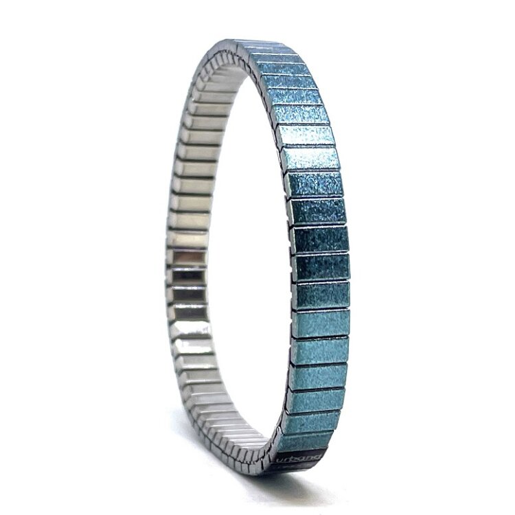 A slim 6mm stainless steel stretch bracelet featuring the Solo turquoise design in a metallic finish. The clasp-free construction slips easily over the wrist for comfortable everyday wear.  by Urband London