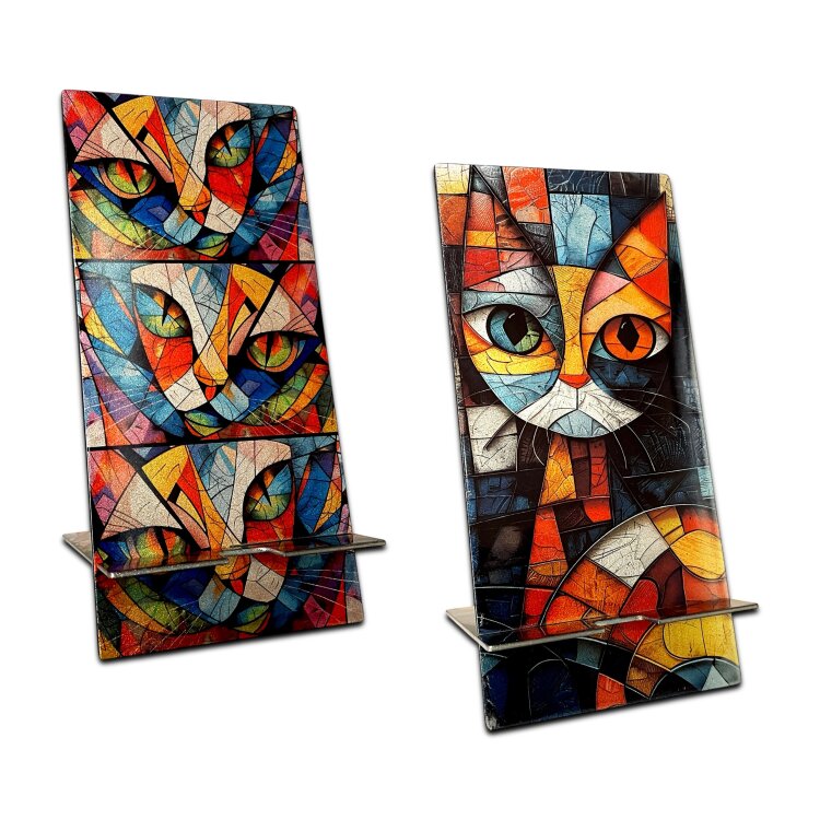 A double-sided stainless steel smartphone stand featuring the Art cat face cubism style design in a metallic finish. Made from two interlocking 1.5mm stainless steel pieces, with an 80 x 95mm base and an 80 x 170mm upright. The reversible artwork lets you display either side, while the cable recess makes it practical for charging while your phone is on the stand. Handmade in London. by Urband London