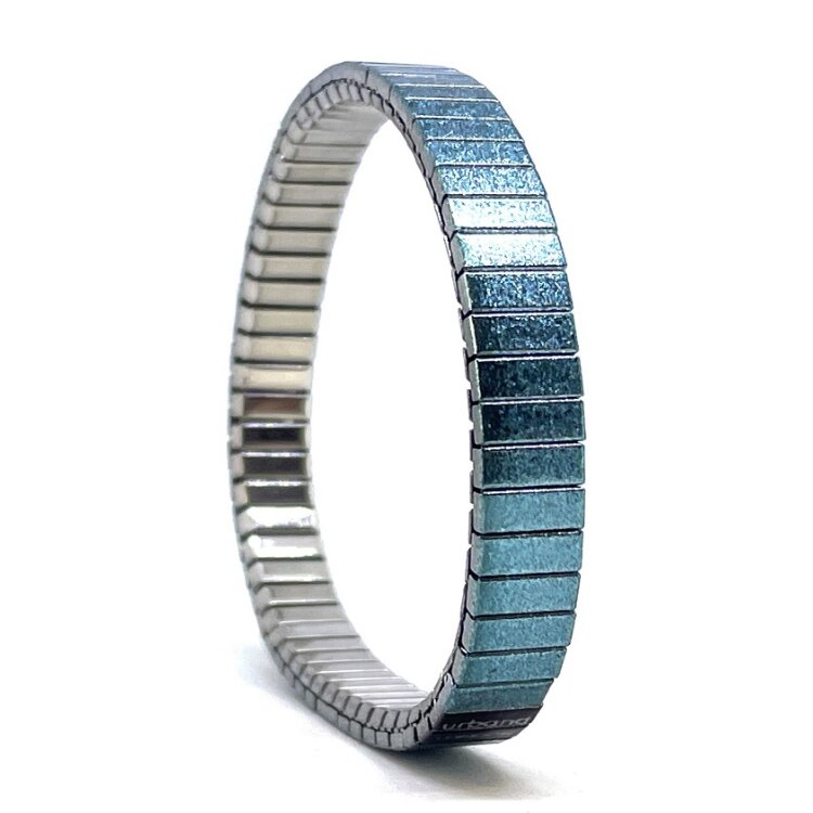 A versatile 10mm stainless steel stretch bracelet featuring the Solo turquoise design in a metallic finish. Its clasp-free construction makes it easy and comfortable to wear, while the distinctive artwork adds an individual touch.  by Urband London