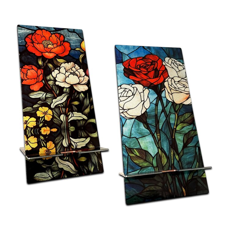 A double-sided stainless steel smartphone stand featuring the Flowers Garden roses with no guns design in a metallic finish. Made from two interlocking 1.5mm stainless steel pieces, with an 80 x 95mm base and an 80 x 170mm upright. The reversible artwork lets you display either side, while the cable recess makes it practical for charging while your phone is on the stand. Handmade in London. by Urband London