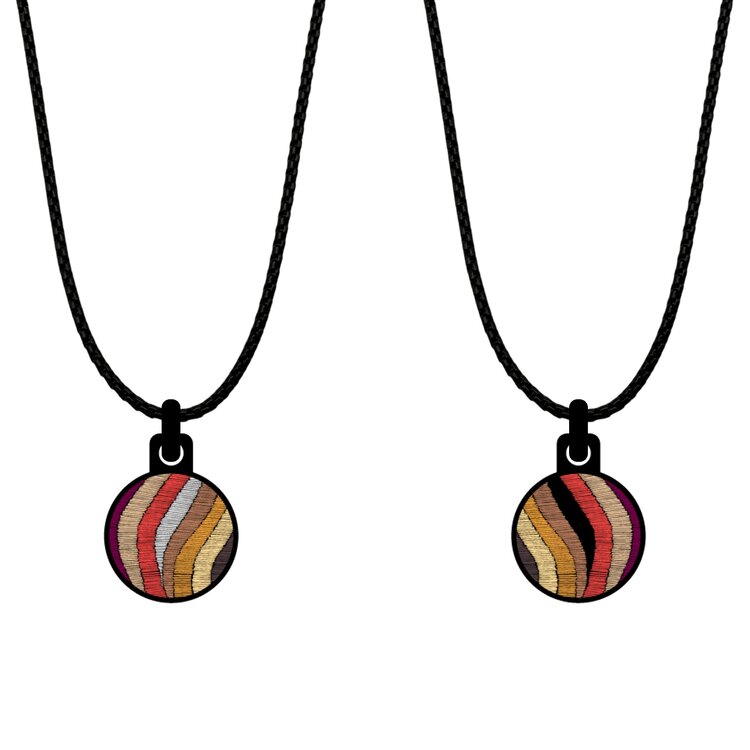 A double-sided 14mm round stainless steel pendant featuring the Checkers Orange fire design in a metallic finish. The artwork is visible on both sides, giving the pendant a distinctive look from every angle.  by Urband London