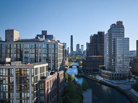 drone angle of new apartment buildings on the Gowanus Canal with DTBK in the background