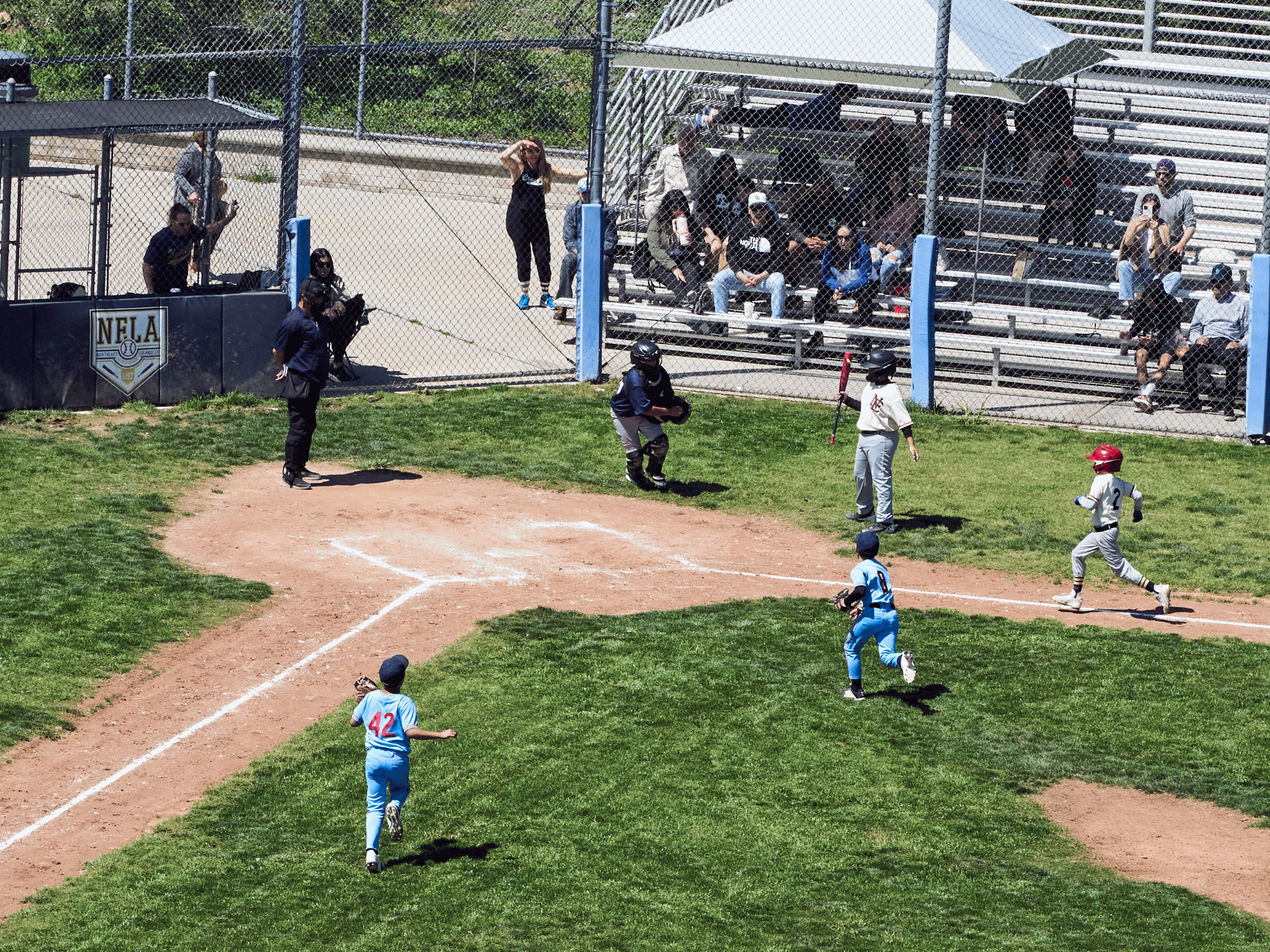 gif of drone view of little league baseball game play-at-the-plate