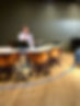 Erich at the Timpani holding up 2 fingers with a sus look on his face. 