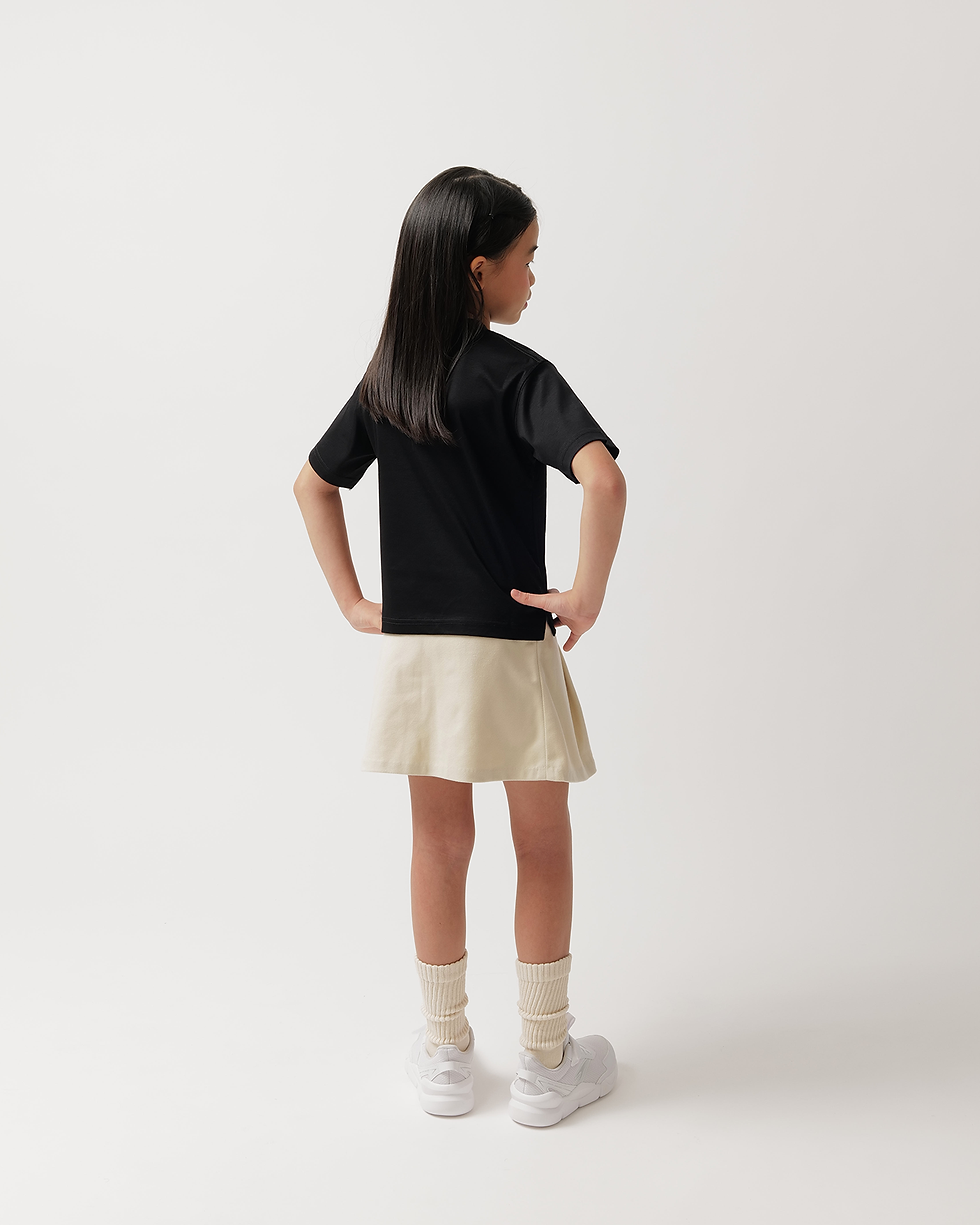 Thumbnail: A girl wearing a minimalist colakee black short sleeve cotton t-shirt for a comfortable look