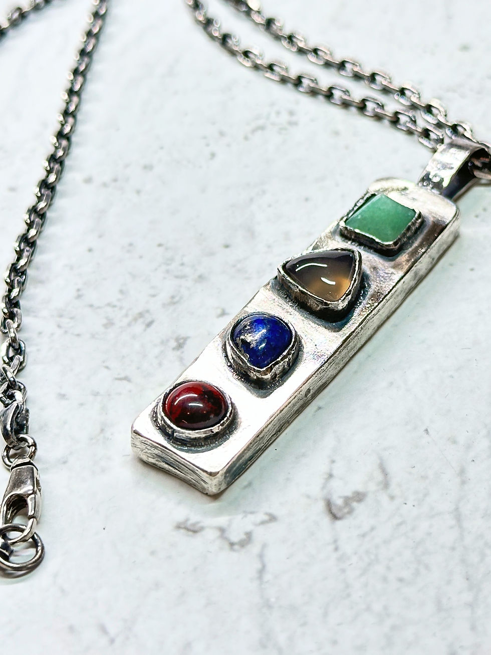 Thumbnail: Hollow rectangular necklace with ruby
