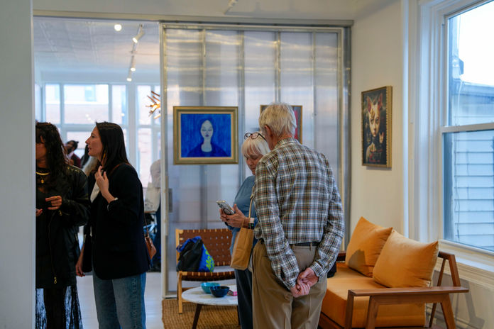 Contemporary art exhibition opening with visitors in Manhattan gallery space