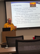 Man presents Generative AI, M365 Copilot information screen, October 2024.