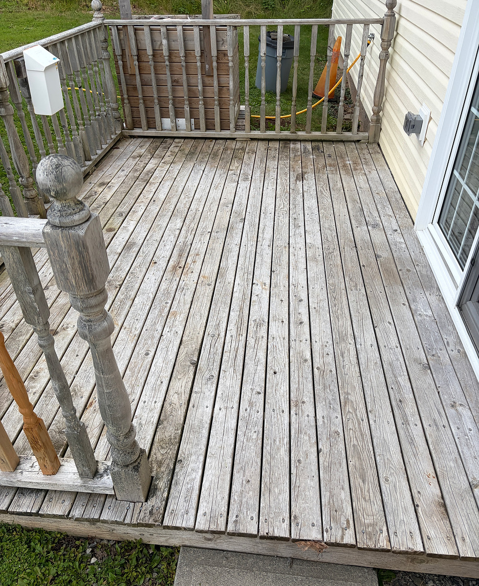 Weathered gray wooden deck before soft washing and restoration cleaning in North Sydney, Nova Scotia.