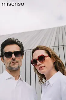 Man and woman wearing Misenso sunglasses outdoors against architectural backdrop — sunglasses campaign photography by Simon Clemenger