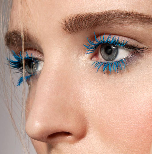 a closeup beauty image of woman with blue eyelashes photography Simon Clemenger
