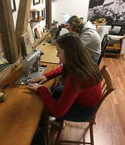 youth at sewing machine, THINGS TO DO IN YORK COUNTY, PLACES TO SEE IN YORK COUNTY, MUSEUMSHOWS, TEACHING MUSEUM, ART, HISTORY, FIBER ART, TEXTILE HISTORY, ANIMALS, SHEEP, SHEEP FIBER, BORDER LEICESTER, BLUE FACE BORDER LEICESTER, GOTLAND, LAMBS, WOOL, FLEECES, ROVING, HAND DYED WOOL, ALPACAS, HAND, ALPACA FIBER, HUACAYA ALPACAS, ART & CRAFTS, CHRISTMAS ITEMS, HAND CRAFTED SANTAS, HAND CRAFTED SNOWMEN, YARN, CLASSES, HAND SPINNING, WEAVING, KNITTING, CROCHETING, FELTING, WET FELTING, NEEDLE FELTING, SEWING, UNIQUE GIFT SHOP, GIFT SHOP, MARYLAND SHEEP & WOOL FESTIVAL, YORK CENTRAL MARKET, YOUTH GROUP ACTIVITIES, FIELD TRIPS, SCHOOL FIELD TRIPS, GIRL SCOUT ACTIVITIES, BOY SCOUT ACTIVITIES, ASSOCIATION SOCIAL GATHERING, SOCIAL CLUBS MEETING, BUSINESS MEETINGS, SPECIAL EVENTS, RAINY DAY ACTIVITY, CRAFTED KNITTED ITEMS, HAND CRAFTED WOVEN ITEMS, CRAFTED FELTED ITEMS, NEEDLE FELTED ITEMS, NEEDLE FELTED WILDLIFE, FELTED PURSES, FELTING KITS