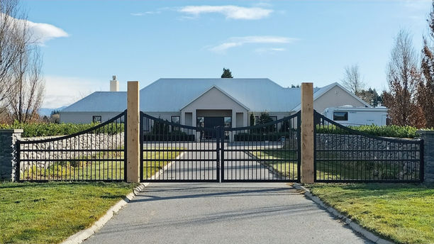 Automatic Swing Gates and Matching Panels with an inverted arch top and vertical bars with two horizontal dividers through the middle by Designer Gates in Christchurch