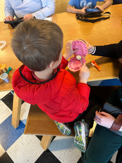 child interacting with a model of a mouth