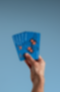 A hand holding the five domain cards