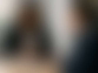 A strong Black woman dressed in a dark suit is seated across from a white male that she intends to terminate.