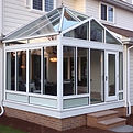 High quality image of a Glass enclosure made of windows on the back of a home.jpg