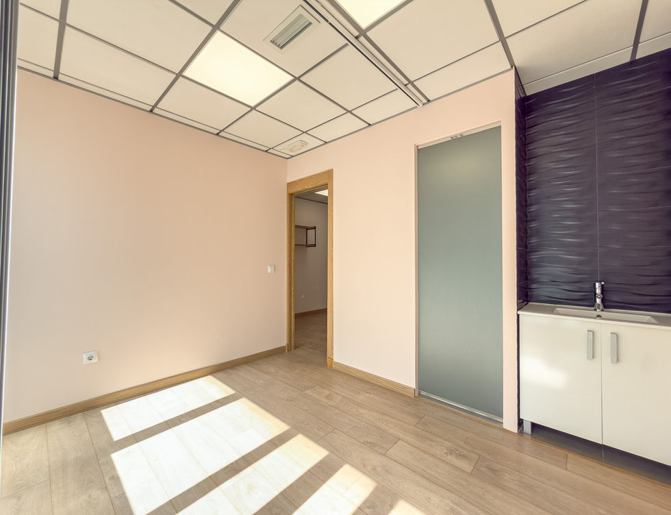 Commercial treatment or office room with storage cabinets and natural light